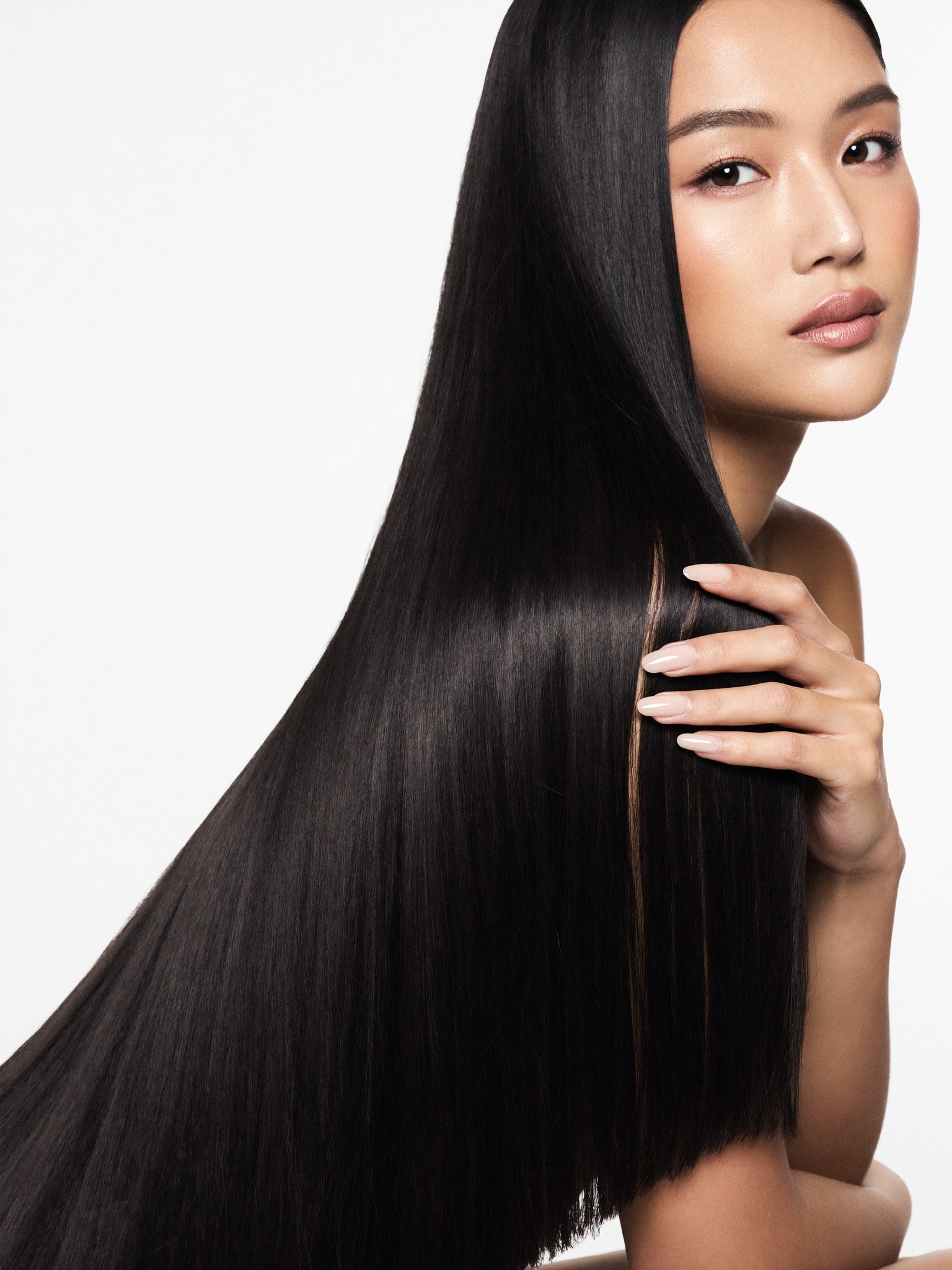 Woman with sleek, glossy straight hair after a COCOCHOCO Onyx treatment